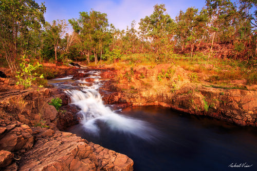 Fine art landscape photograph of Buley Rockhole waterfall at Litchfield National Park — golden afternoon light over cascading water and tropical forest, Australian landscape art print by Robert Vine.