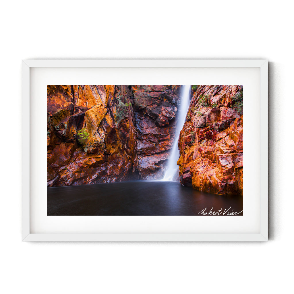 Fine art landscape photograph of Motor Car Falls, Kakadu National Park — smooth waterfall cascading over red sandstone cliffs into still water, Australian landscape art print by Robert Vine.