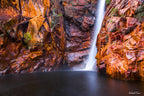 Fine art landscape photograph of Motor Car Falls, Kakadu National Park — smooth waterfall cascading over red sandstone cliffs into still water, Australian landscape art print by Robert Vine.