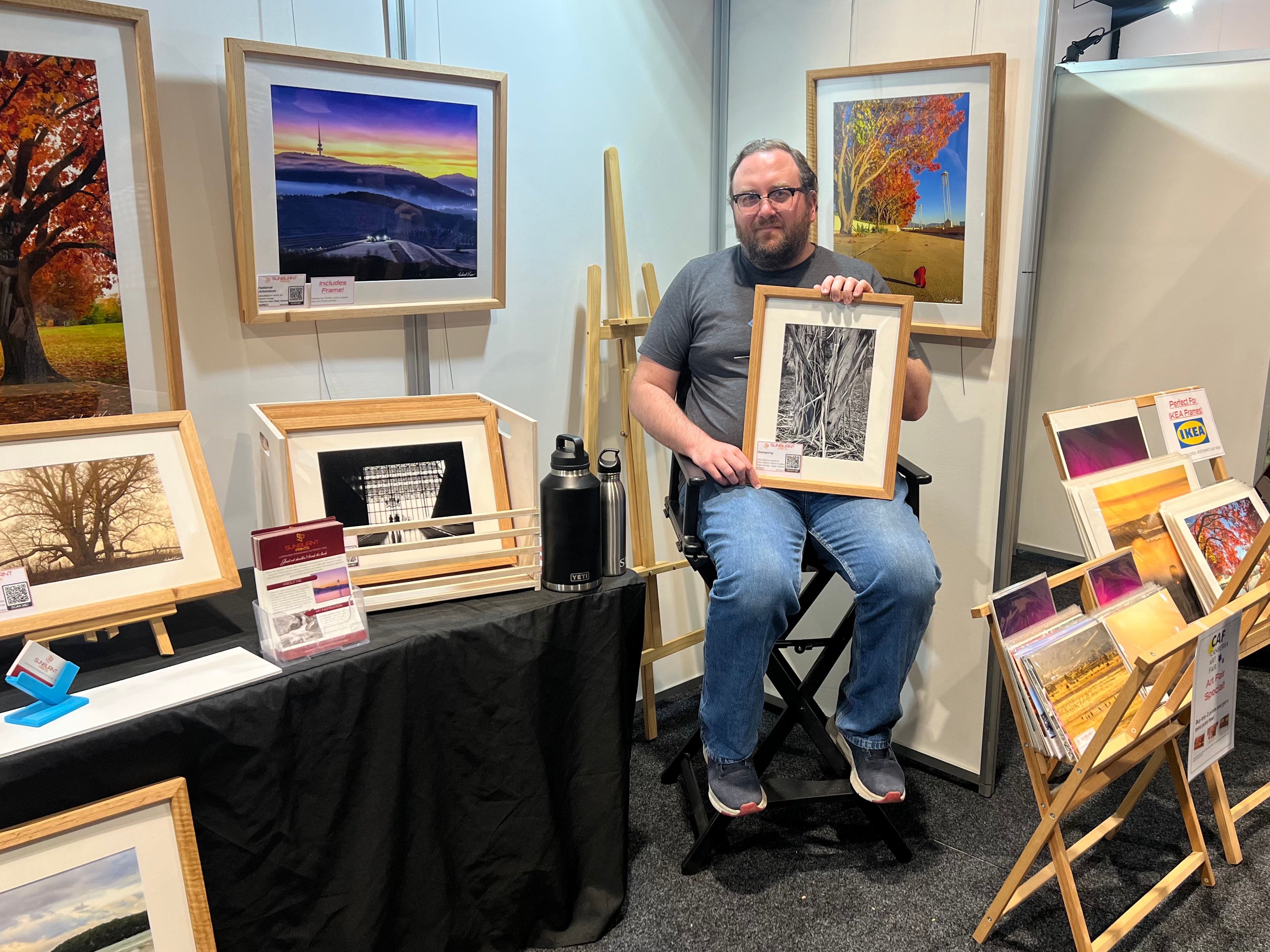Robert Vine, Australian landscape photography artist displaying his work at an art fair.