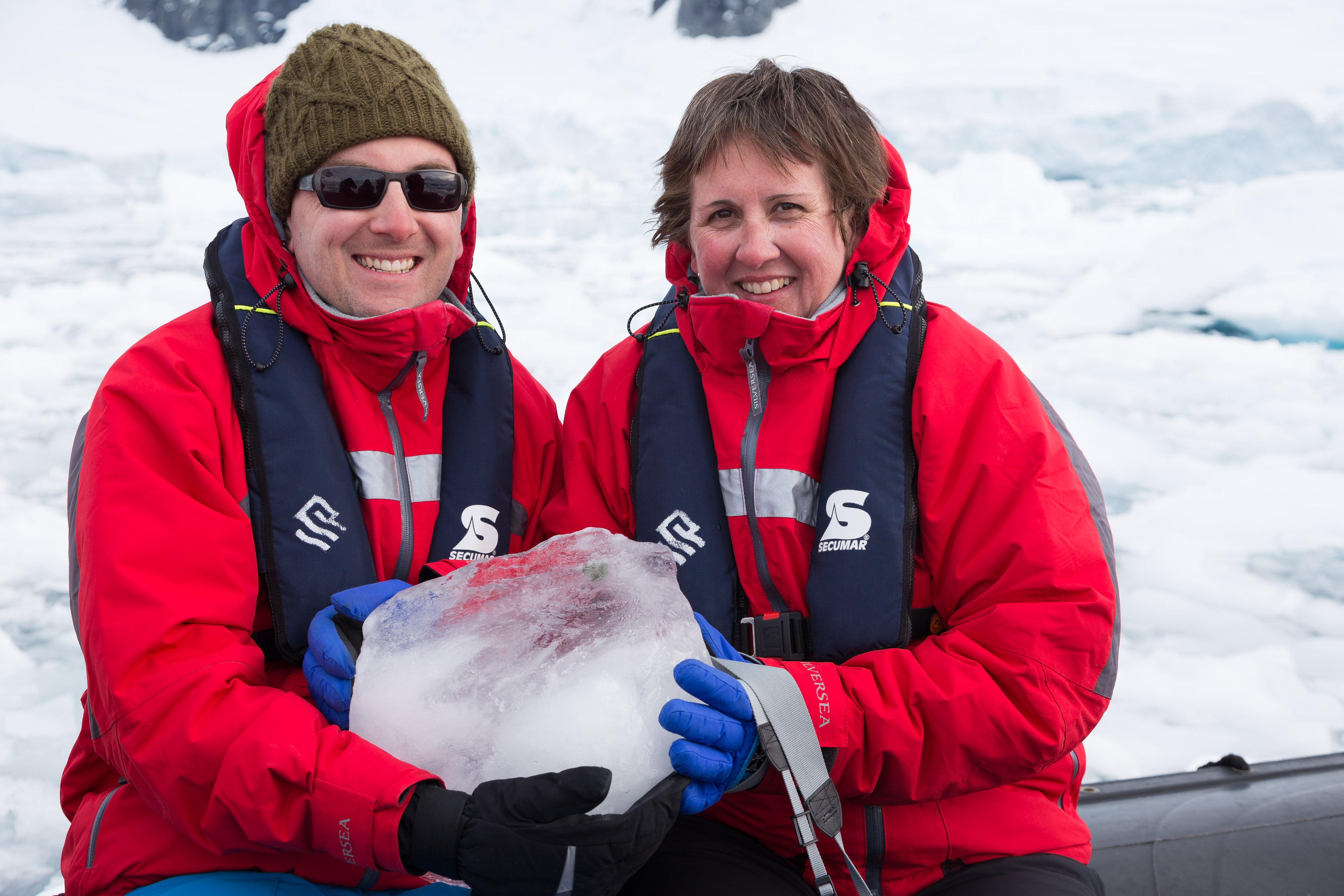 Robert Vine, landscape photography artist and his mum holding an iceberg in Antarctica.