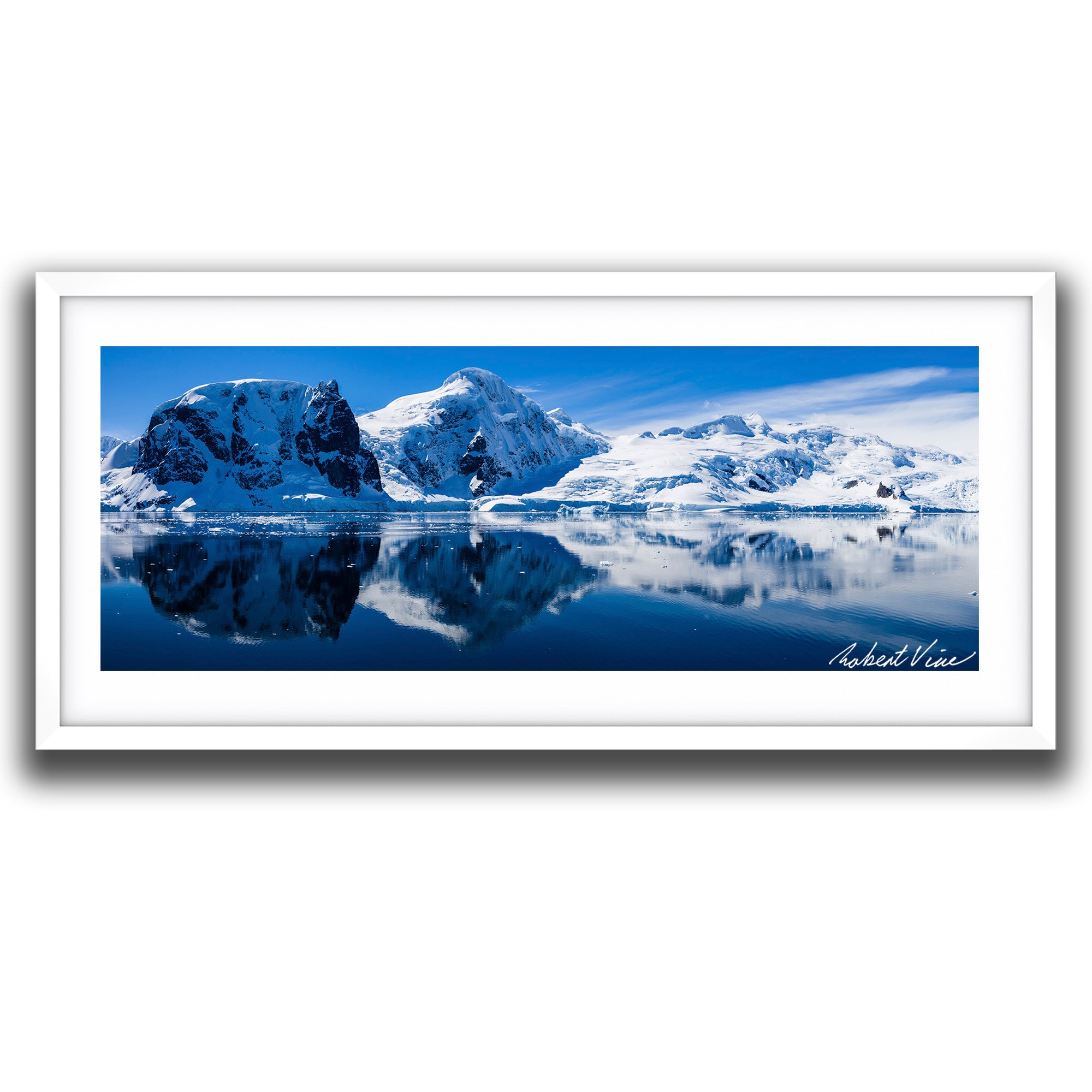 Panoramic photograph of snowy mountains reflected in the still waters of Neko Harbour, Antarctica, captured by landscape photographer Robert Vine.