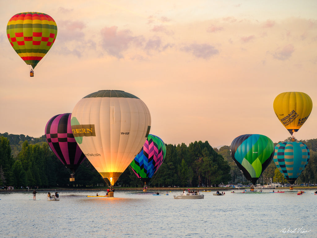 Hot air balloons performing a water dunk on Lake Burley Griffin during the Canberra Balloon Spectacular at sunrise, photographed by Robert Vine.