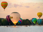 Hot air balloons performing a water dunk on Lake Burley Griffin during the Canberra Balloon Spectacular at sunrise, photographed by Robert Vine.