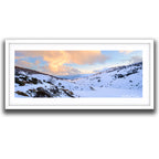 Framed print of Panoramic winter sunset over the frozen Guthega Reservoir surrounded by snow-covered mountains in the Snowy Mountains, photographed by Robert Vine.