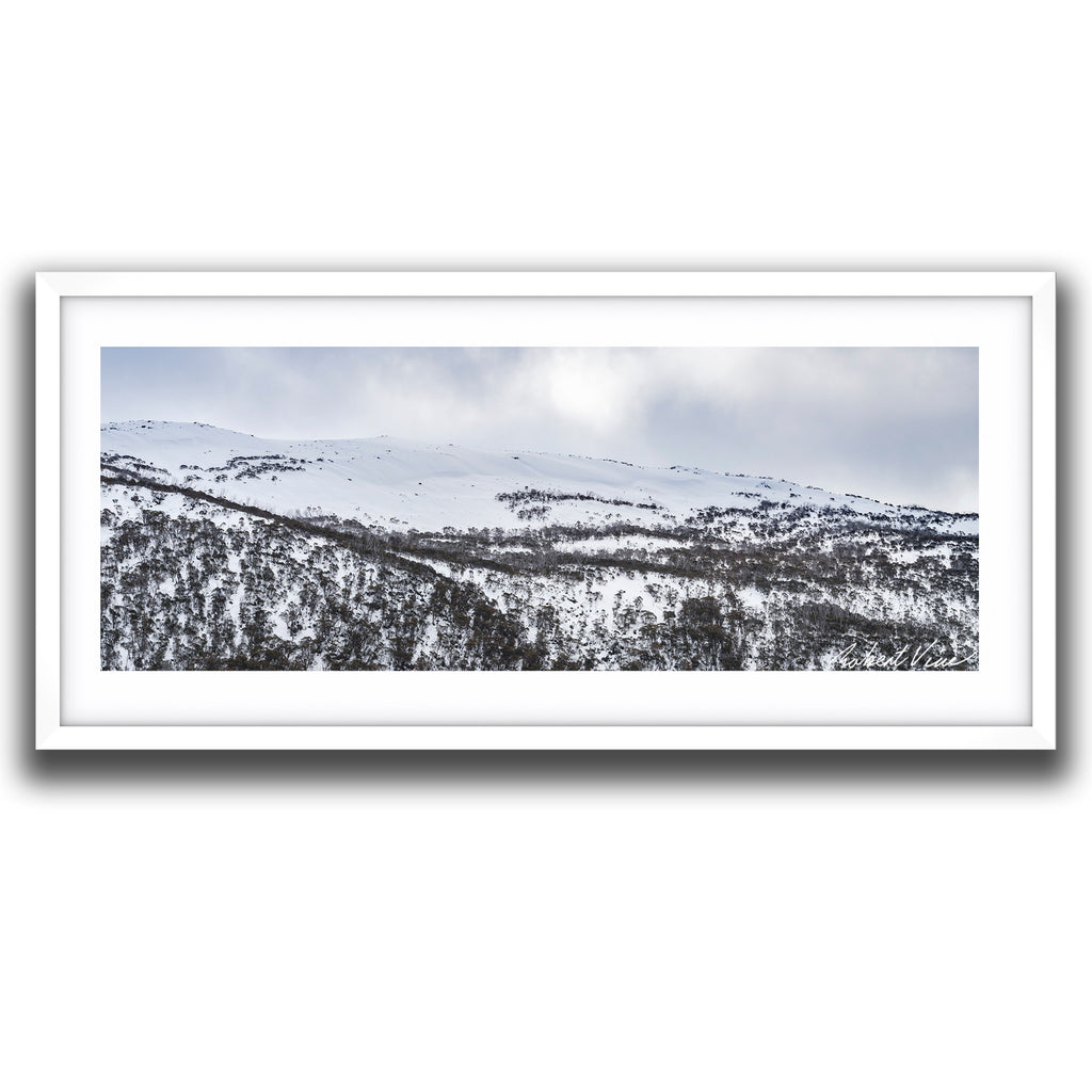 Framed wall art of Panoramic winter landscape of snow-covered ridges and snow gums at Guthega in the Snowy Mountains, photographed by Australian landscape artist Robert Vine.