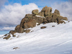 Snow-covered granite rock formation at the summit of Thredbo beneath dramatic alpine clouds in the Snowy Mountains, photographed by Robert Vine.