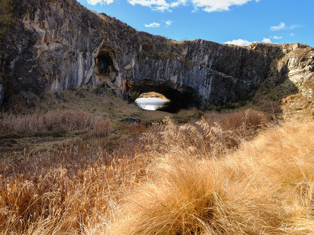 London Arch Bridge in Burra on a warm winter afternoon with golden grasses, rugged rock formations and blue sky, photographed by Robert Vine.