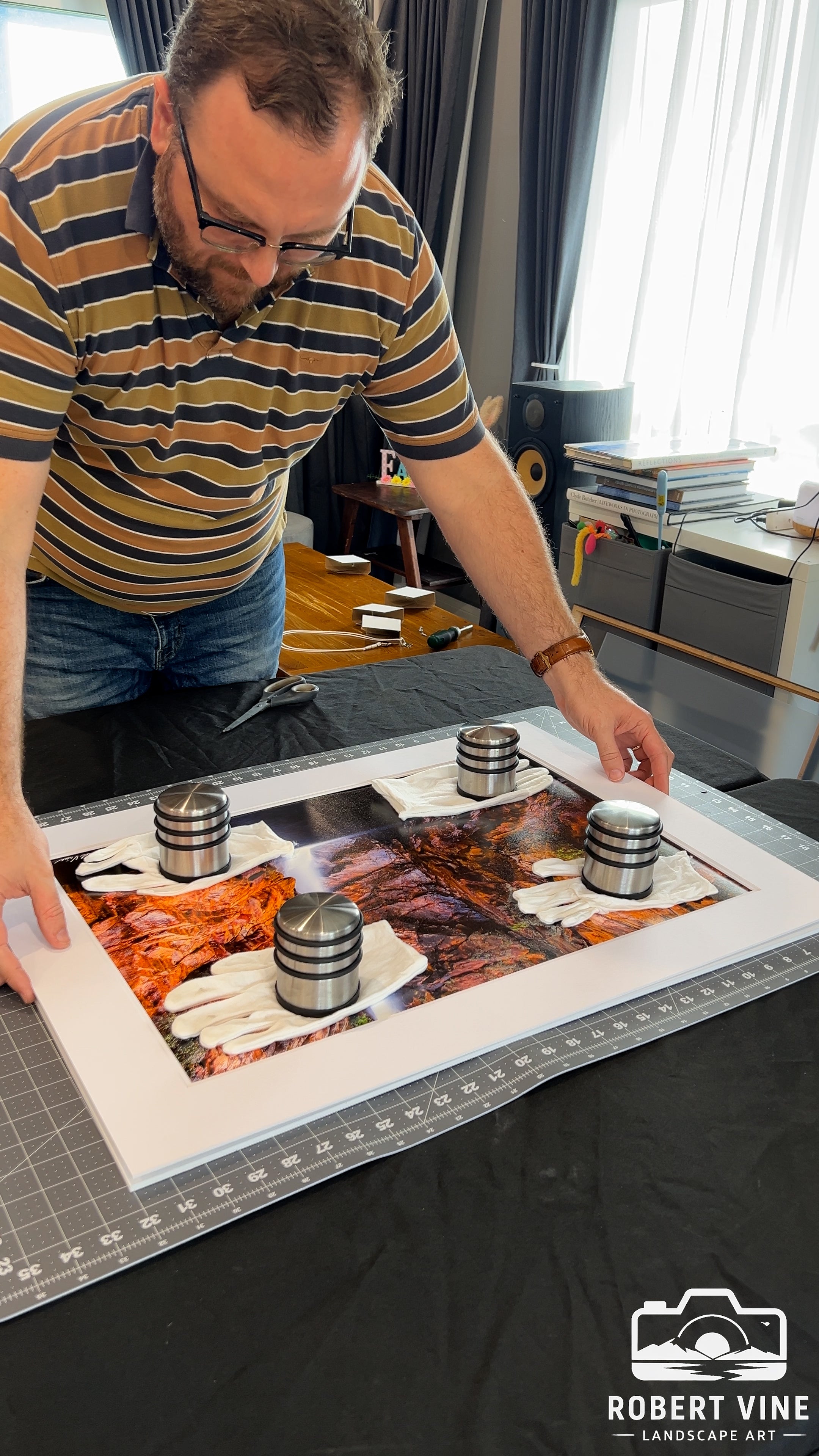 Robert Vine, Australian landscape artist, carefully assembles and frames a fine art landscape print in his studio, showcasing the craftsmanship behind his limited edition work.
