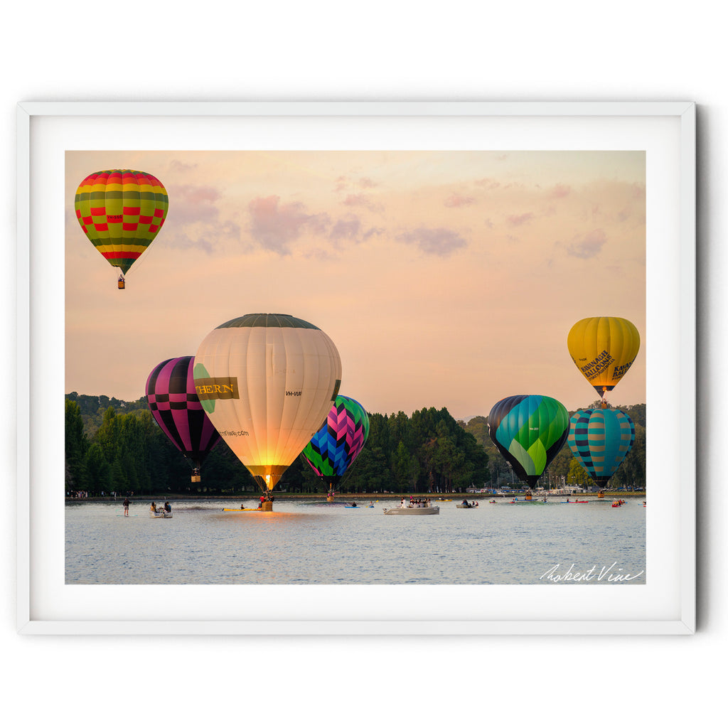 Framed print of Hot air balloons performing a water dunk on Lake Burley Griffin during the Canberra Balloon Spectacular at sunrise, photographed by Robert Vine.
