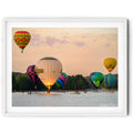 Framed print of Hot air balloons performing a water dunk on Lake Burley Griffin during the Canberra Balloon Spectacular at sunrise, photographed by Robert Vine.