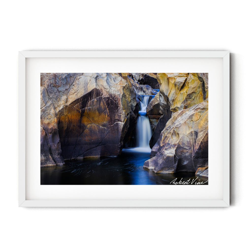 Long exposure photograph of a small waterfall flowing through sculpted granite rock formations at Googong Cascades, captured by Robert Vine.