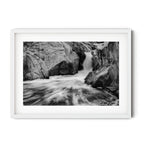 Framed black and white photograph of flowing water cascading through sculpted granite rocks at the Googong Cascades, captured by Robert Vine.