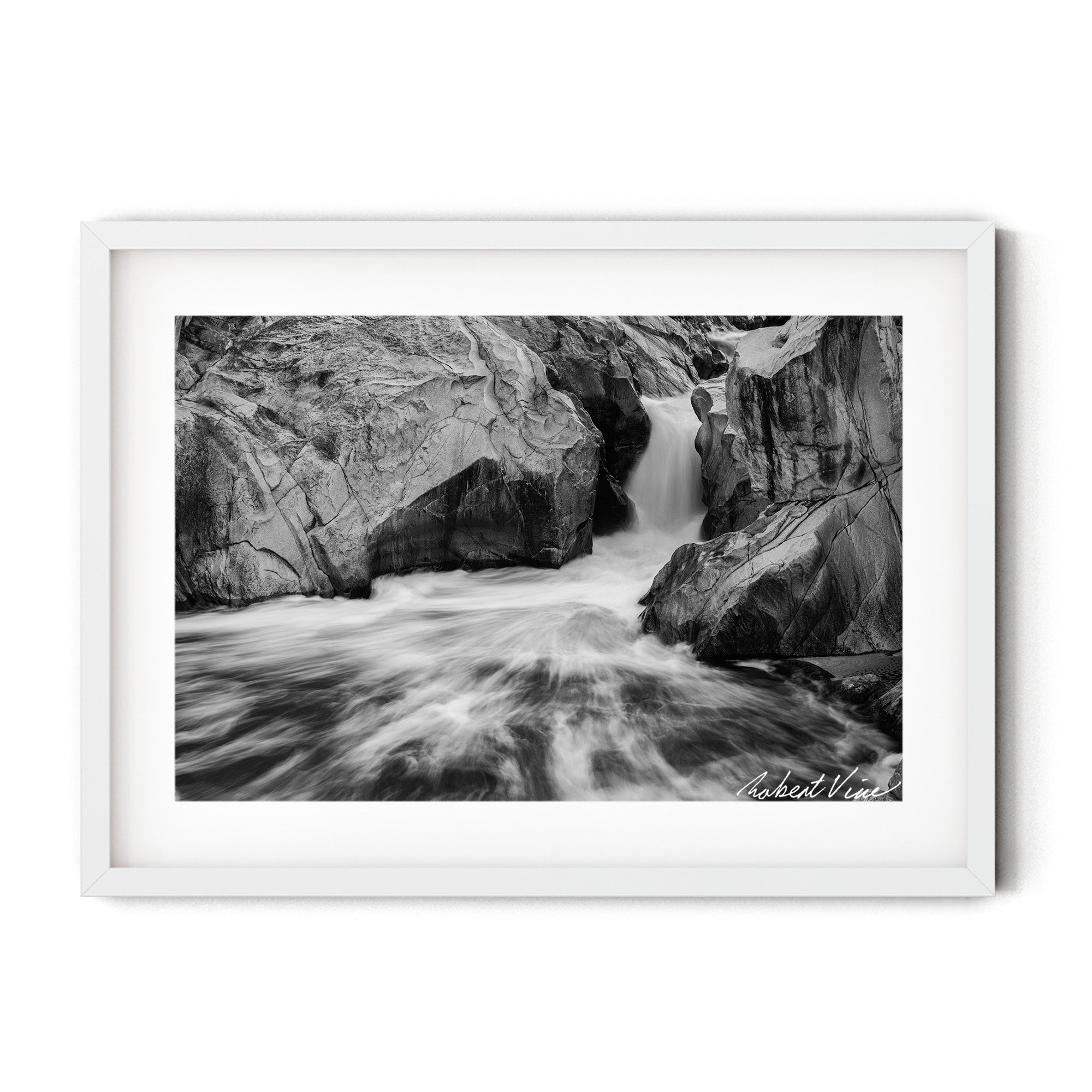Framed black and white photograph of flowing water cascading through sculpted granite rocks at the Googong Cascades, captured by Robert Vine.