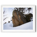 Framed Snow-covered granite boulder surrounded by alpine shrubs during gentle snowfall in Perisher, photographed by Australian landscape artist Robert Vine.