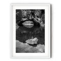 Frame print of Black and white photograph of London Bridge at Googong, NSW, reflected in calm water beneath the natural limestone arch by Robert Vine.