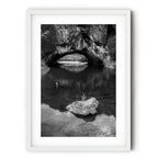 Frame print of Black and white photograph of London Bridge at Googong, NSW, reflected in calm water beneath the natural limestone arch by Robert Vine.